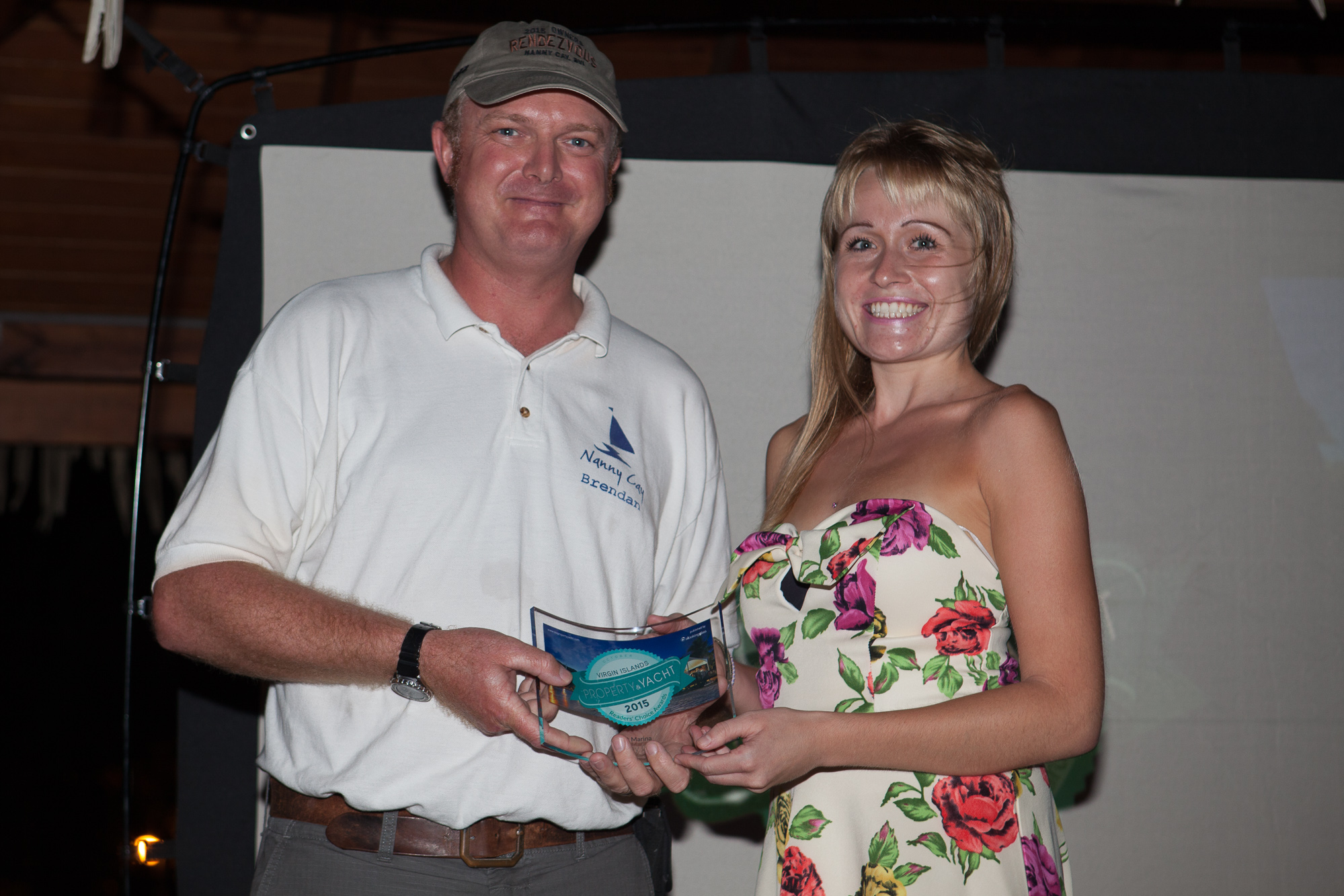 Marina manager, Brendan Joyce, collecting Nanny Cay's award from Lauren of Virgin Islands Property & Yacht